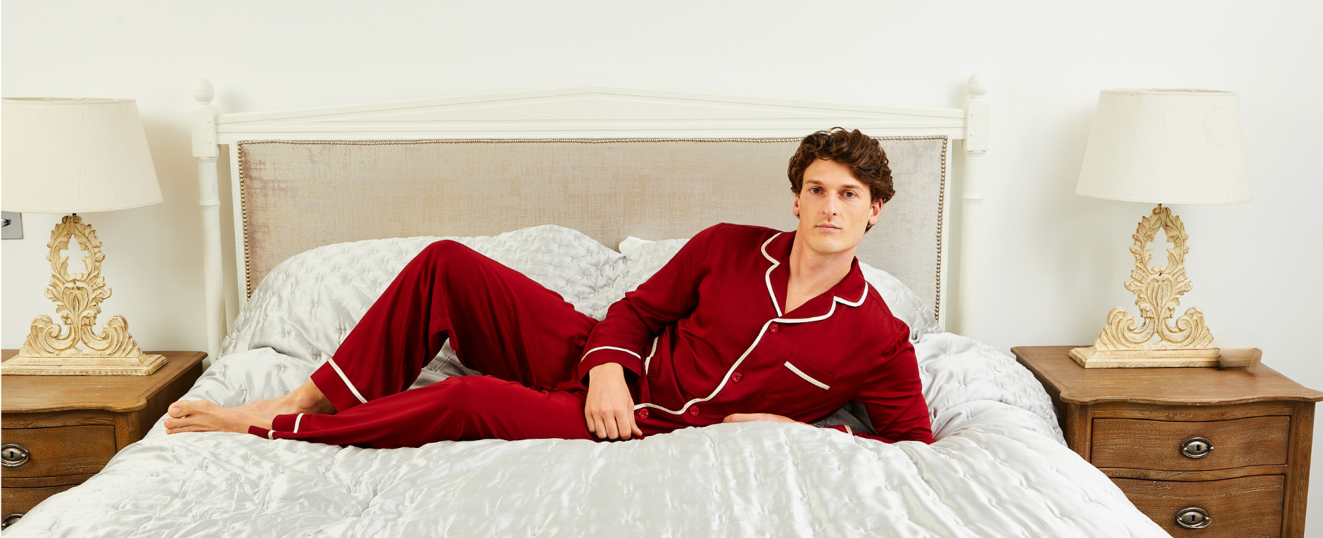 Man Laying On Bed Wearing Red Satin Pyjamas | Bown of London