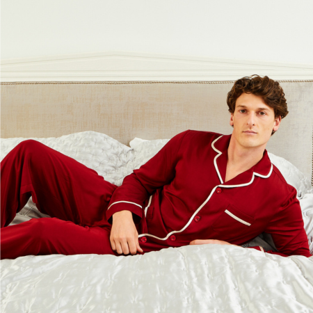 Man Laying On Bed Wearing Red Satin Pyjamas | Bown of London