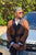 Model wearing Midas men's smoking jacket in gold paisley