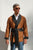 Model wearing Midas men's smoking jacket in gold paisley